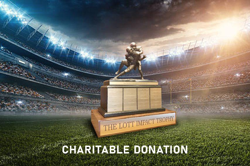 The Lott IMPACT Trophy on display at a stadium — charitable donation
